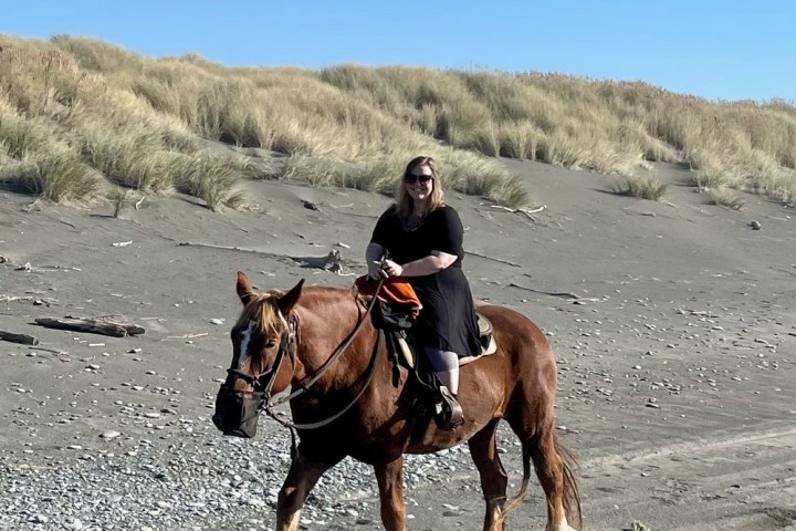 a man riding a horse on a dirt road